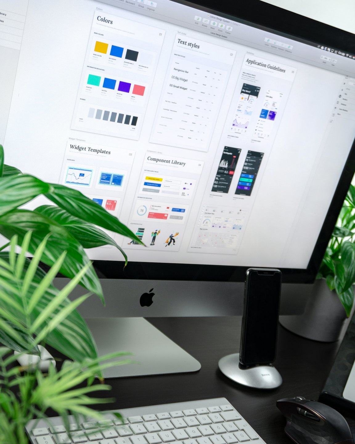 computer display with a keyboard near a plant